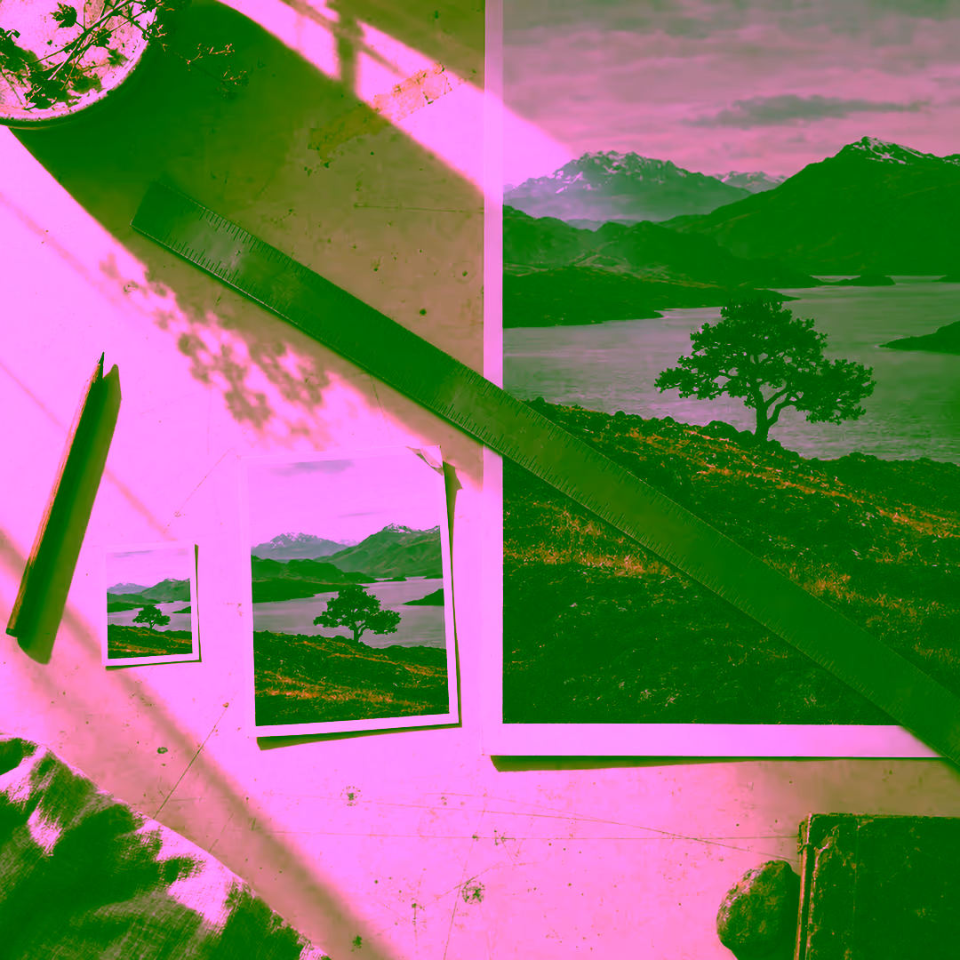 The same landscape photograph printed at three sizes on a pale workbench: a stamp-sized print and a postcard-sized print next to a poster-sized print, with a steel ruler laid diagonally across them, a pencil alongside and a strip of old tape residue on the surface