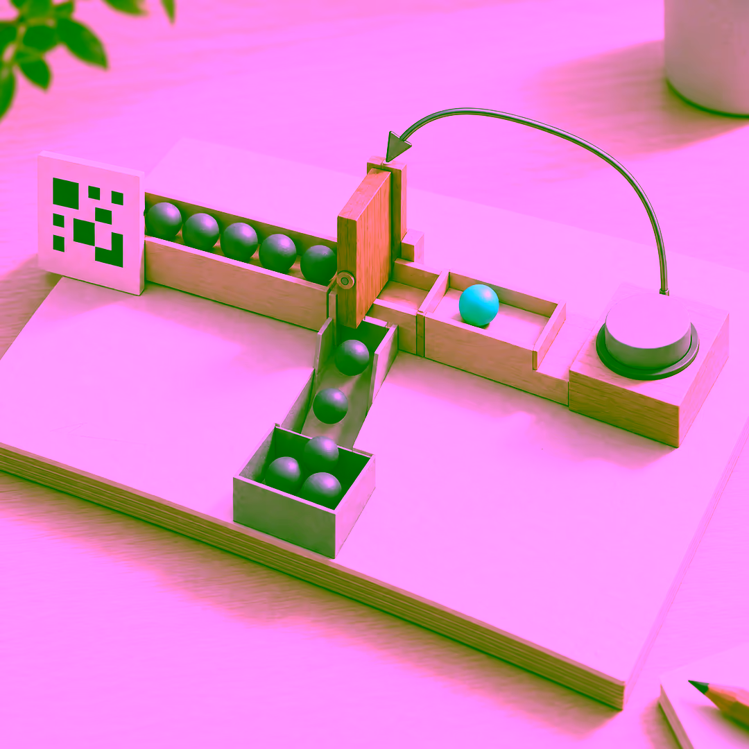 Paper and wood model: a QR-style tile feeds a row of grey spheres; one cyan sphere has passed a gate into a tray beside a round confirm button, later spheres drop into a bin, and a wire arrow loops from the button back to the gate